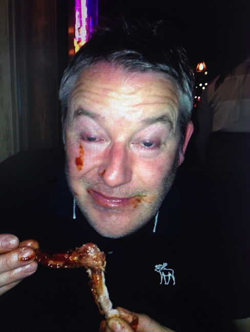 My friend enjoying the chicken wings at Reds True BBQ January 2015